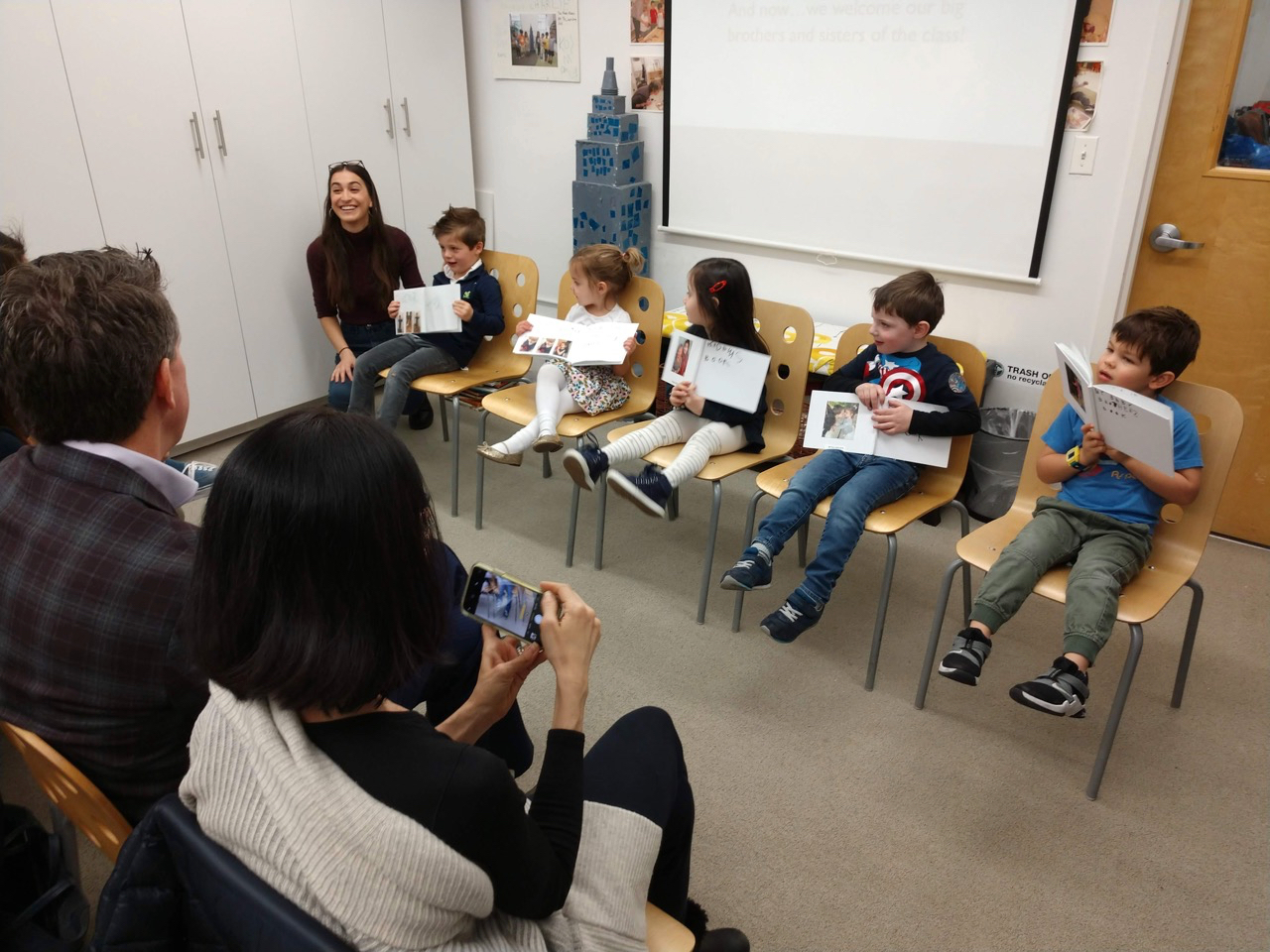 children presenting their work to their parents